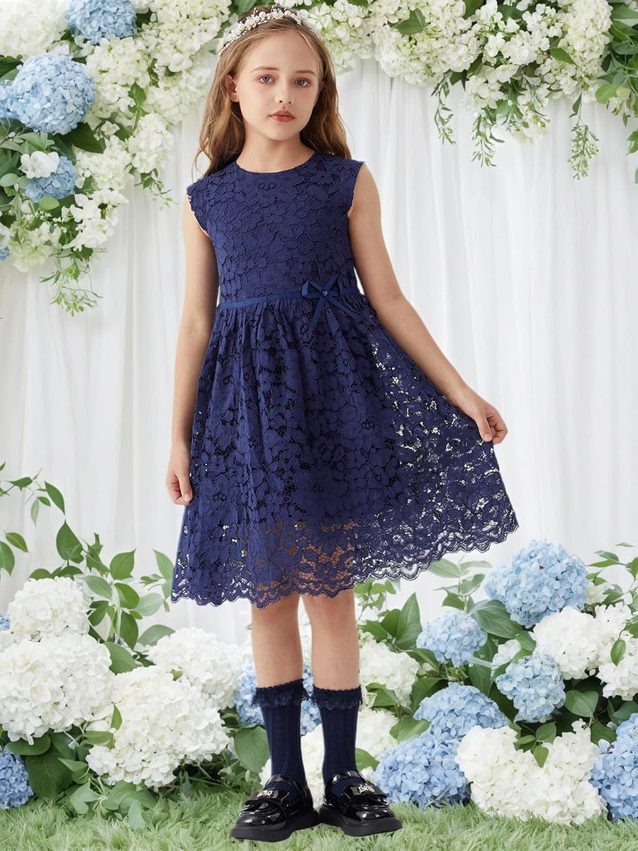 Girl wearing an ALLOVIN navy lace dress among blue and white flowers